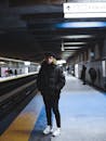 Man in Black Jacket Standing on Train Station