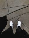 Person in Black Pants and White Sneakers