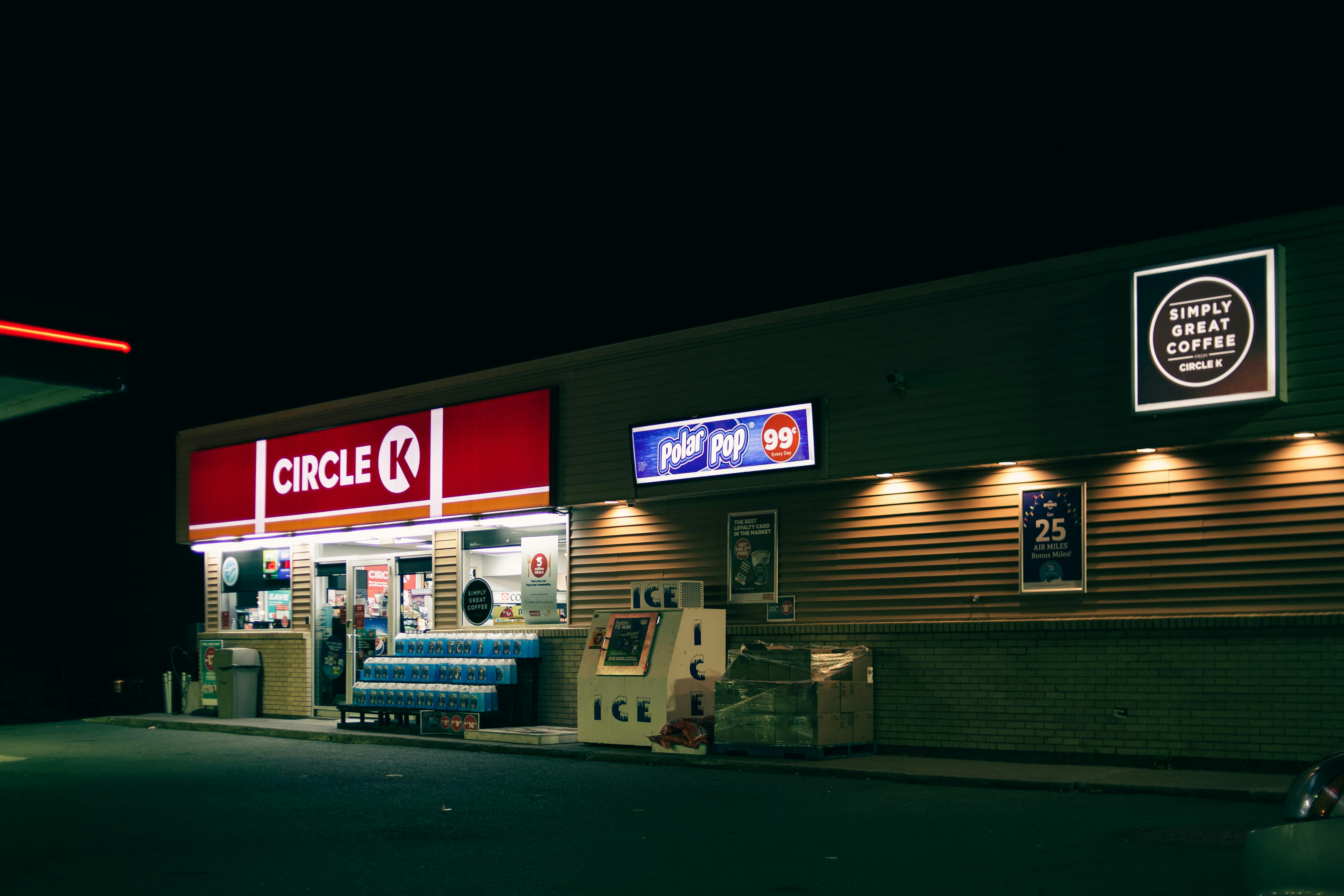 convenience store building facade with signboards in night city