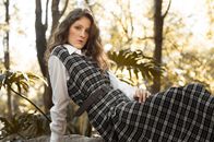 Woman in Black and White Plaid Long Sleeve Shirt Standing Near Trees