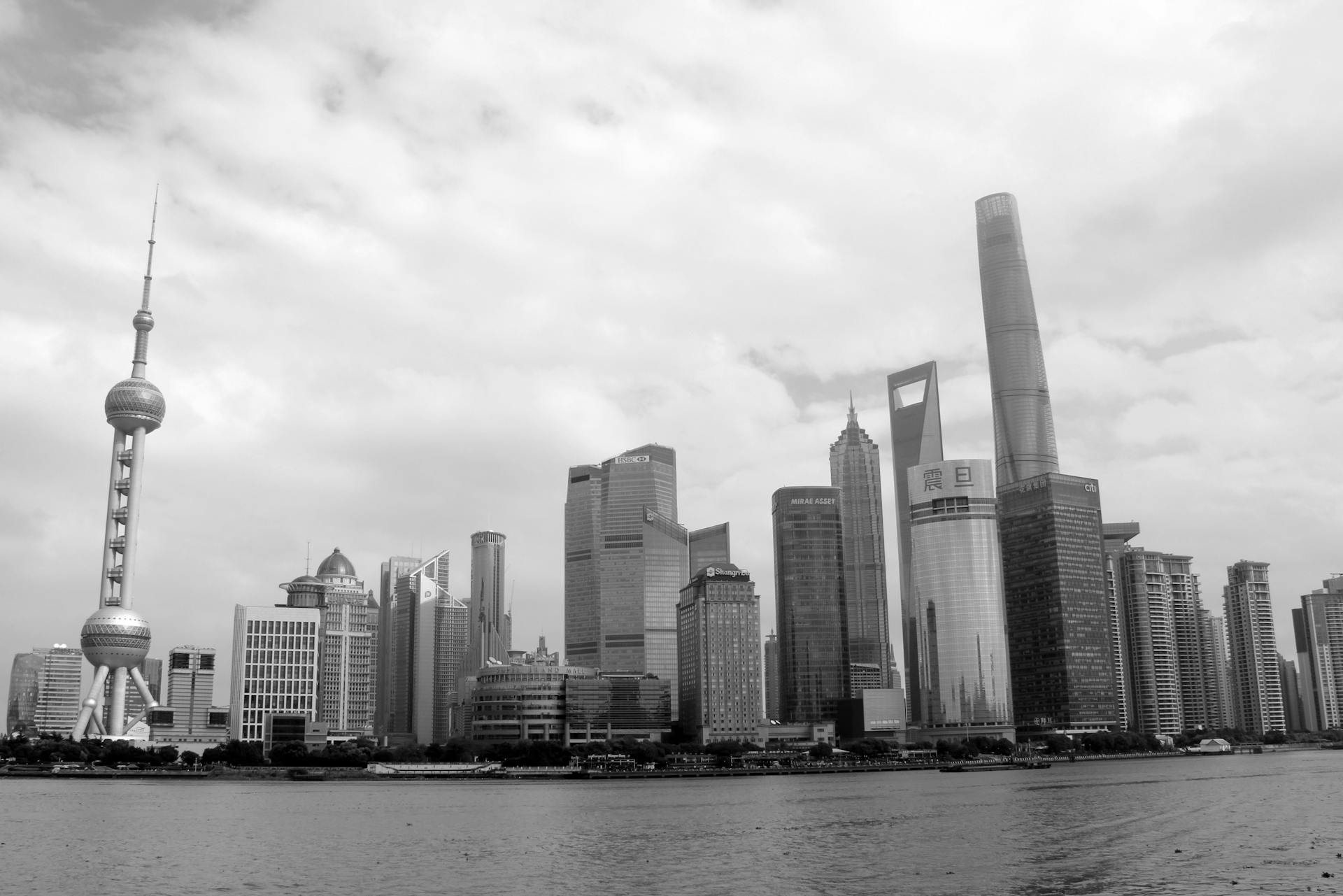 Dramatic black and white skyline of Shanghai's modern Pudong district featuring iconic skyscrapers.