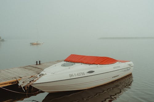 White Stingray Boat near the Wooden Dock