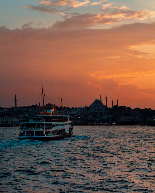 A Ferry Boat on the Sea during Sunset