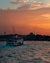A Ferry Boat on the Sea during Sunset