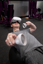 A Man Wearing Virtual Reality Goggles while in the Gym