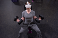 A Man Lifting Dumbbells while Wearing Virtual Reality Goggles