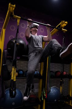 Man using VR headset while working out in gym. Engaging in virtual reality fitness.