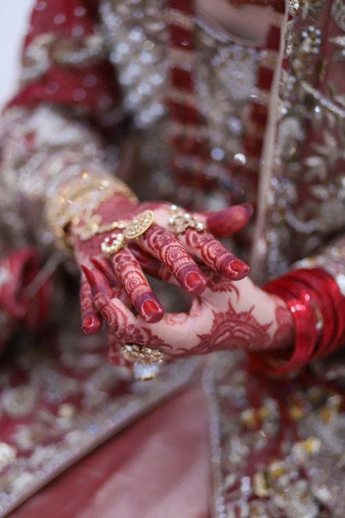 Free Close-up of hands adorned with intricate henna and jewelry, symbolizing cultural beauty. Stock Photo