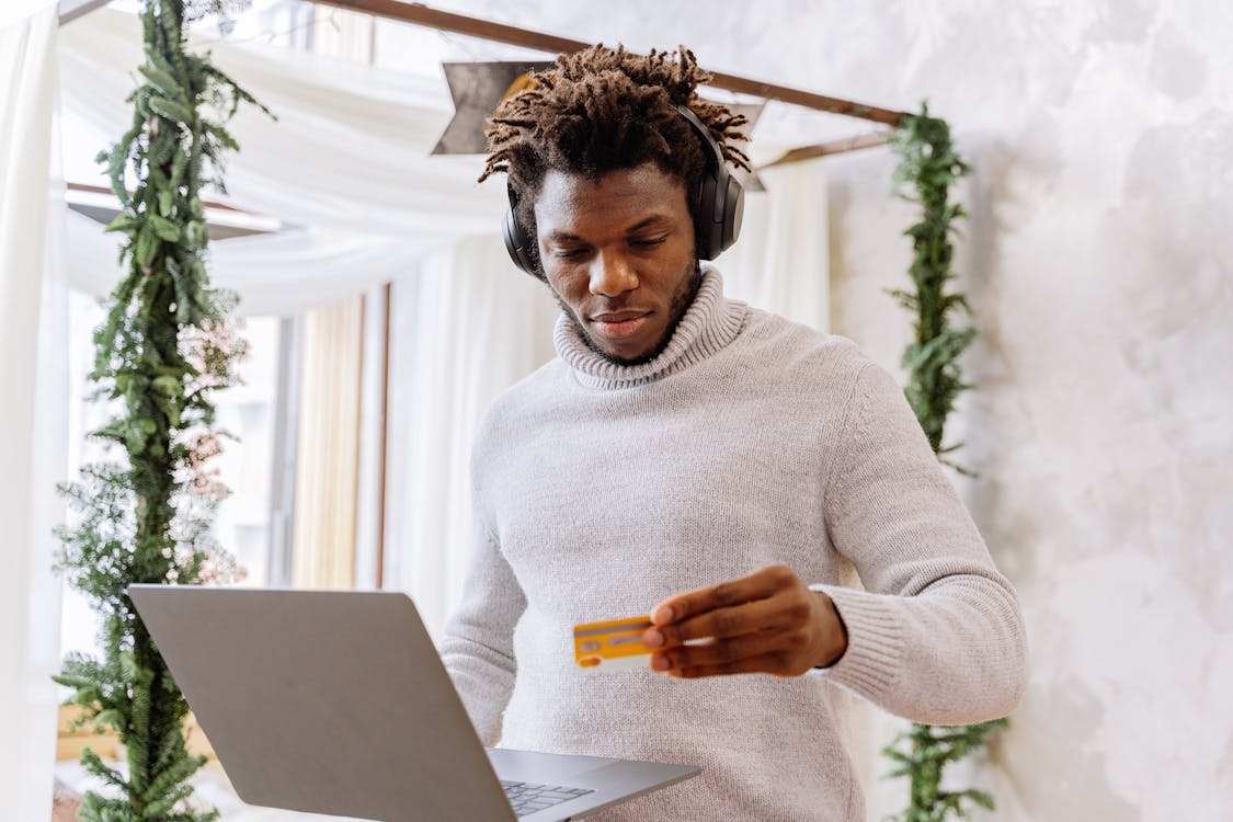 Free A Man Standing While Holding A Laptop Stock Photo