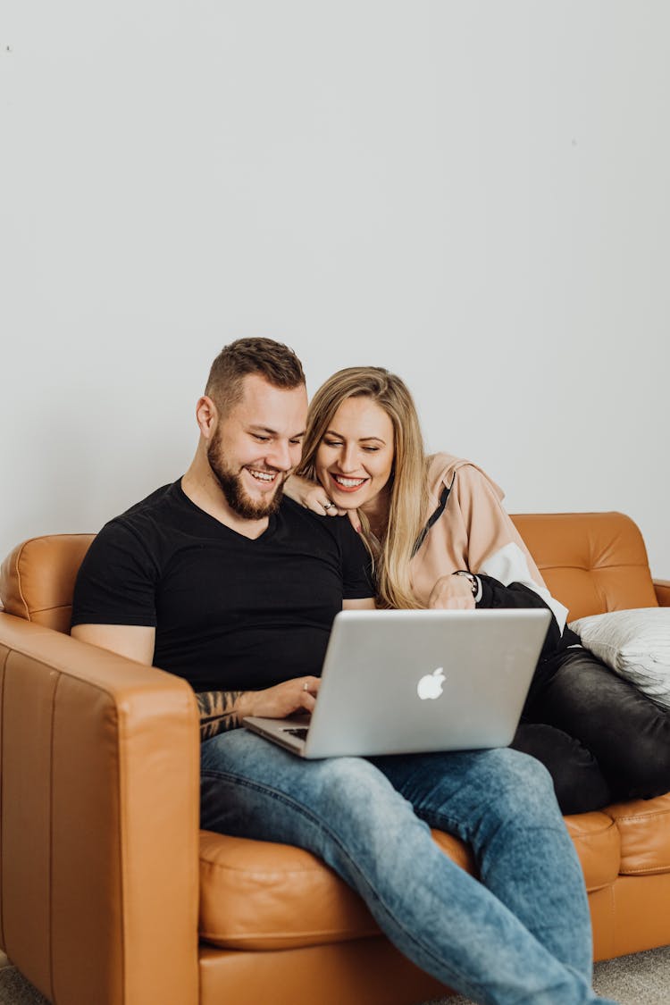 Man And Woman Sitting On Couch