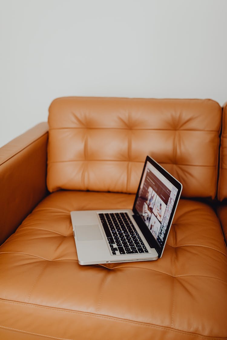 Laptop On The Brown Leather Couch