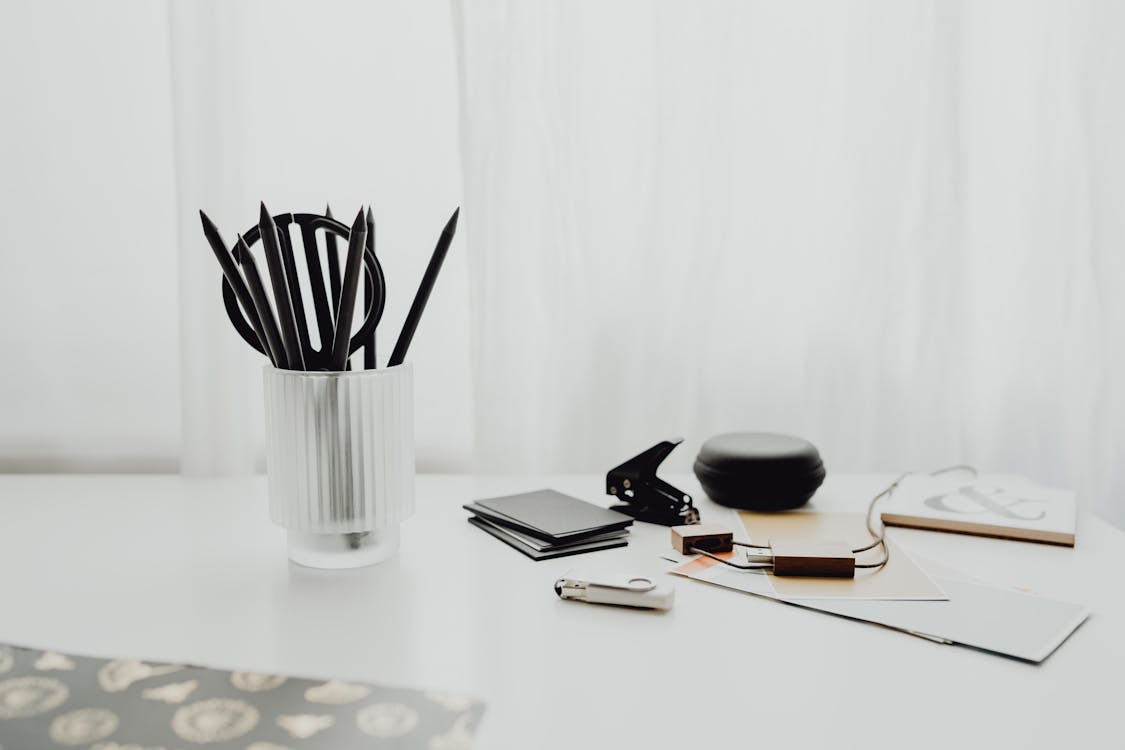 Pens in Cup on Desk