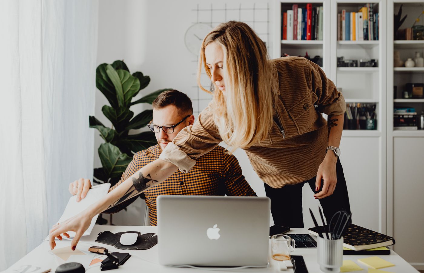 Professional team collaborating in a bright and modern office setting, focused on a project.