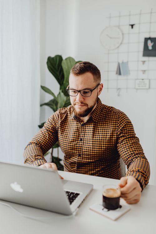 Man Using his Laptop Computer · Free Stock Photo