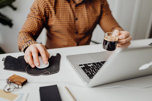Man Working From Home with Cup of Coffee