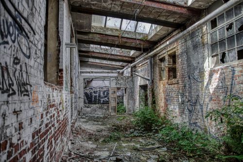 Free Explore the eerie beauty of an abandoned industrial building in Leipzig, covered in graffiti. Stock Photo
