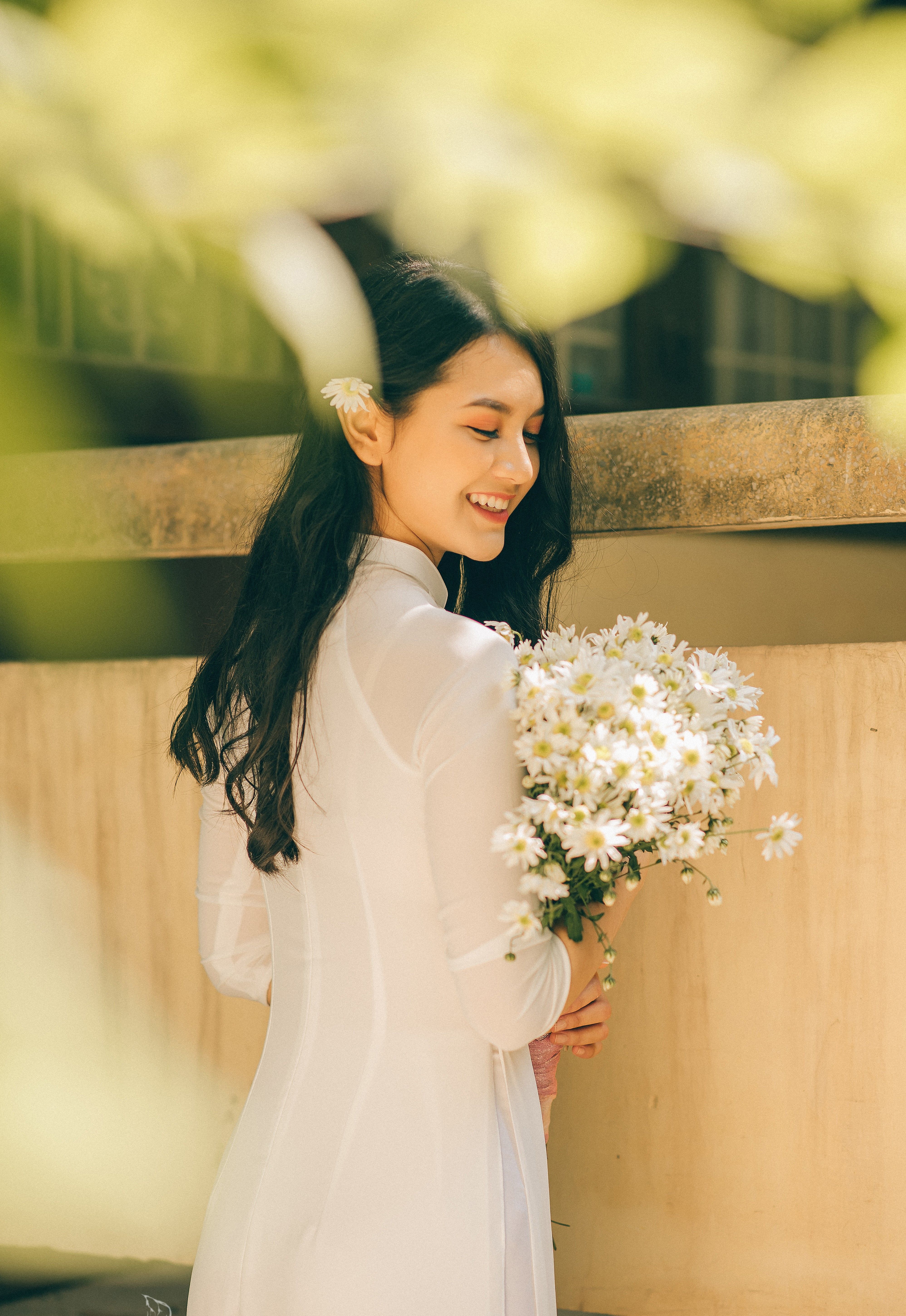A Pretty Woman in White Dress Holding a Bouquet of White Flowers · Free ...