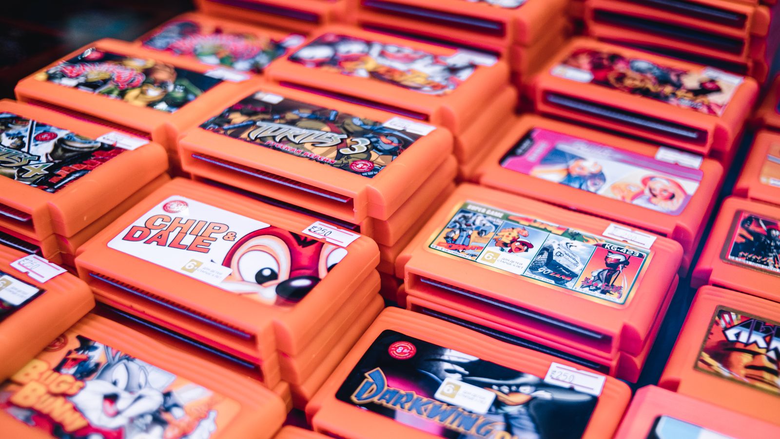 Close-up of stacked retro video game cartridges in orange cases, a real stock photo with no people in the frame, chosen because the story is about whether you own the games you buy