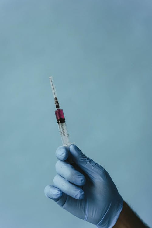 A Person Holding a Loaded Syringe
