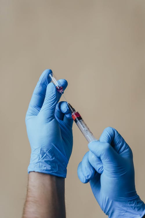 A Person Loading a Syringe