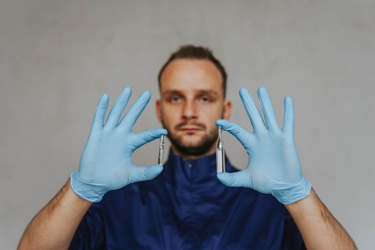 A Doctor Holding Glass Ampoules