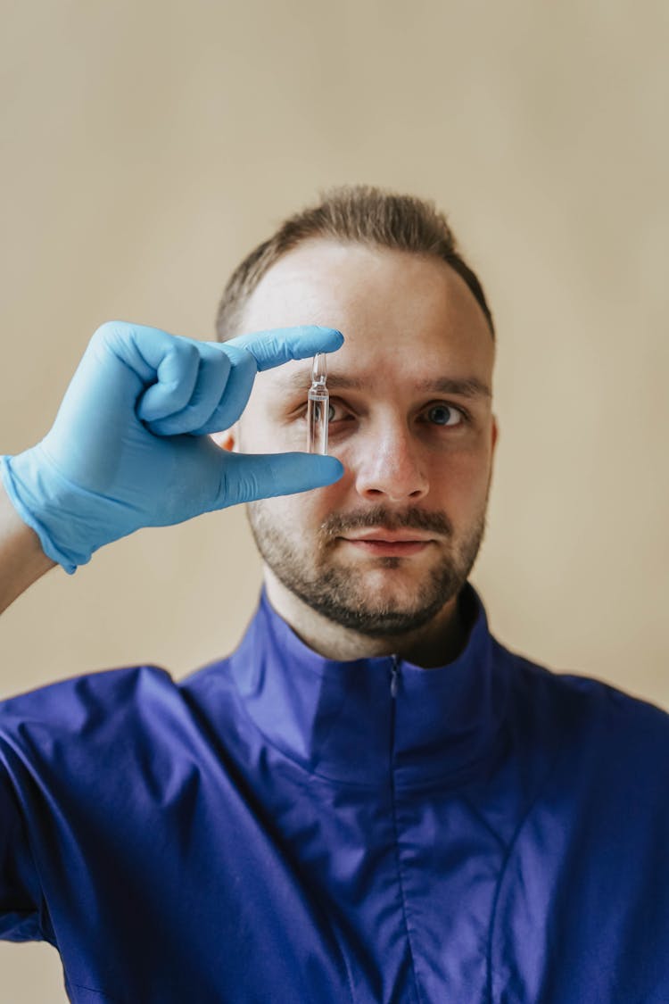 A Doctor Holding Glass Ampoule