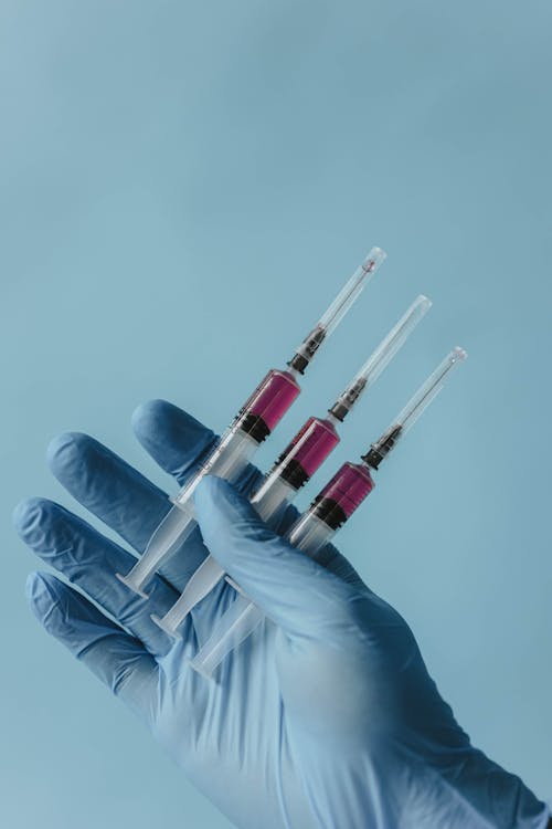 A Person Holding Loaded Syringes