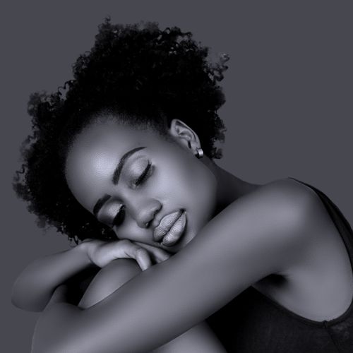 Free Close-up black and white portrait of an African American woman with eyes closed, exuding serenity. Stock Photo