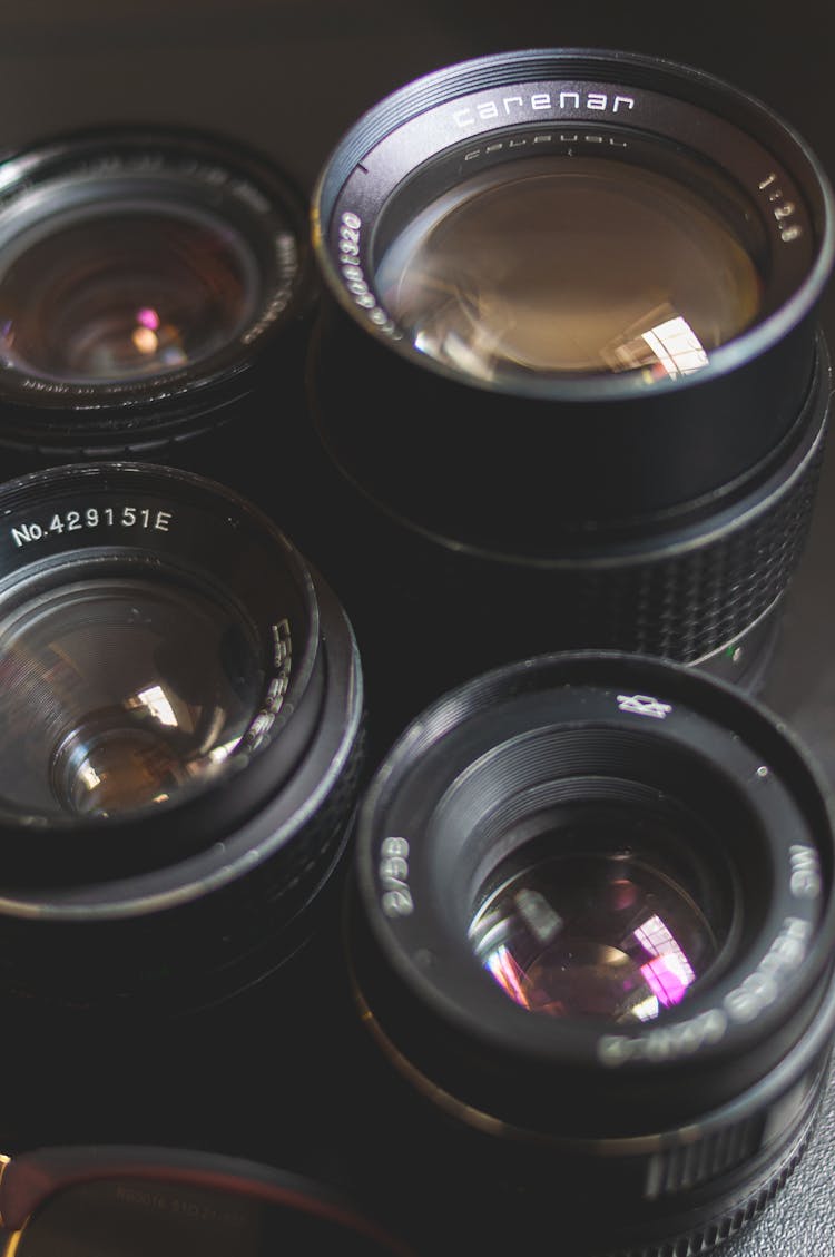 Lenses Of Professional Photo Camera On Black Table