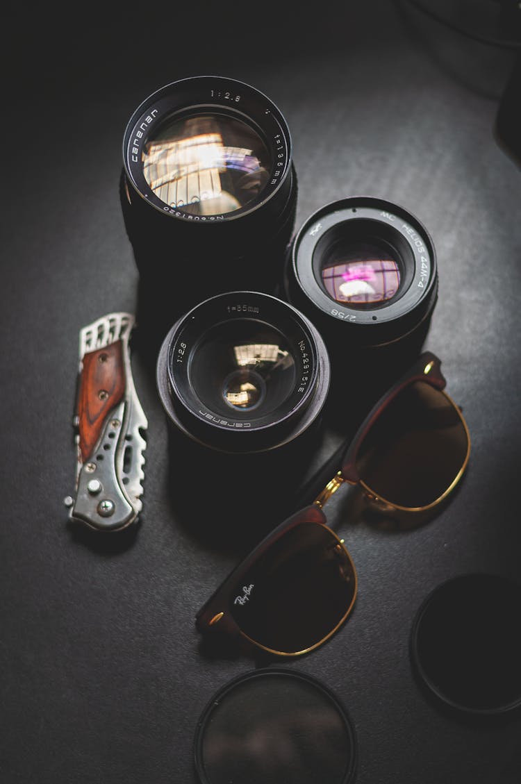 Lenses Of Professional Photo Camera Placed On Black Table