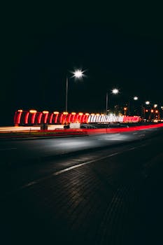 A captivating night view of an illuminated street in Miraflores, showcasing vibrant lights and a serene urban atmosphere.