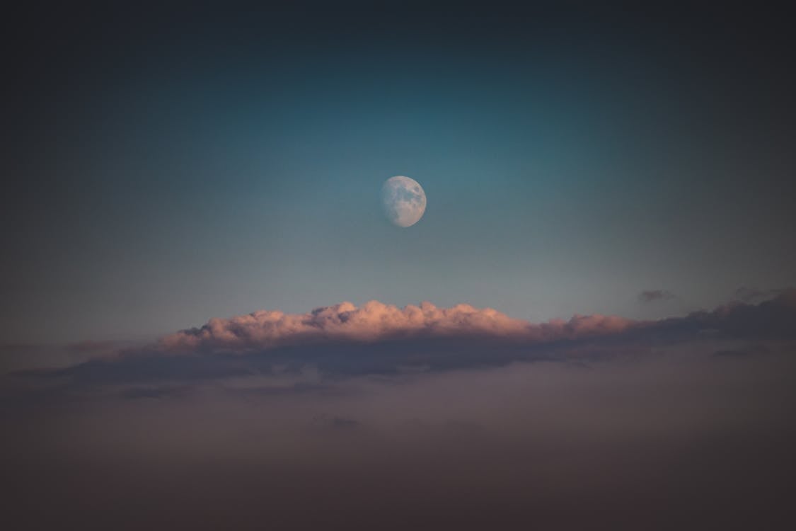 Free Full Moon over the Clouds During Daytime Stock Photo