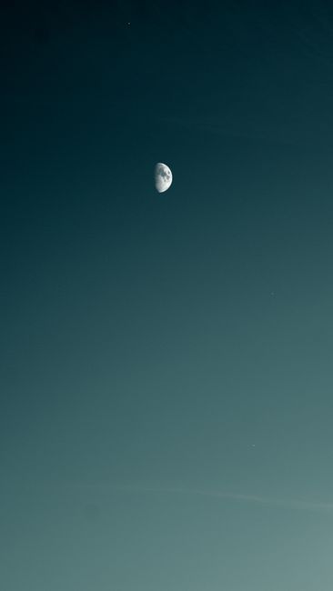 Captivating view of the half moon against a serene night sky, perfect for nature lovers.
