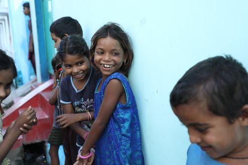 Free A group of smiling Indian children playing joyfully outside in Mungeli, capturing the essence of happiness and togetherness. Stock Photo