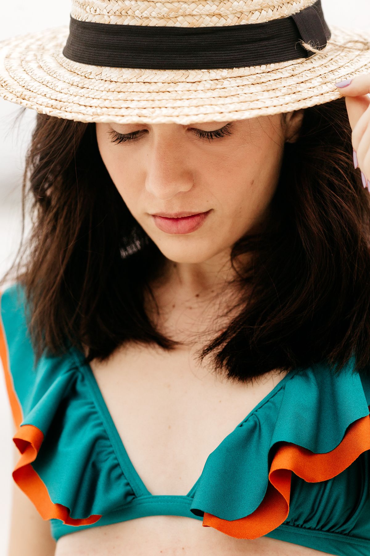 A dreamy woman in a modern swimsuit in summer light — the new considered swimwear