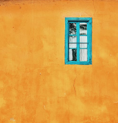 Blue Window of House Yellow Wall