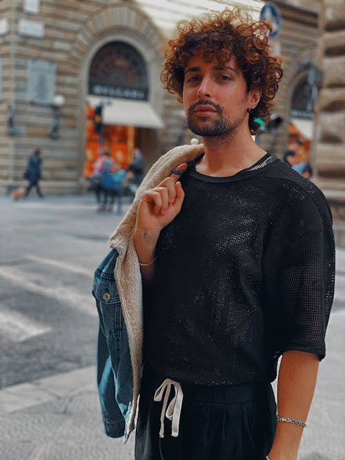 A Man with Curly Hair Looking at the Camera