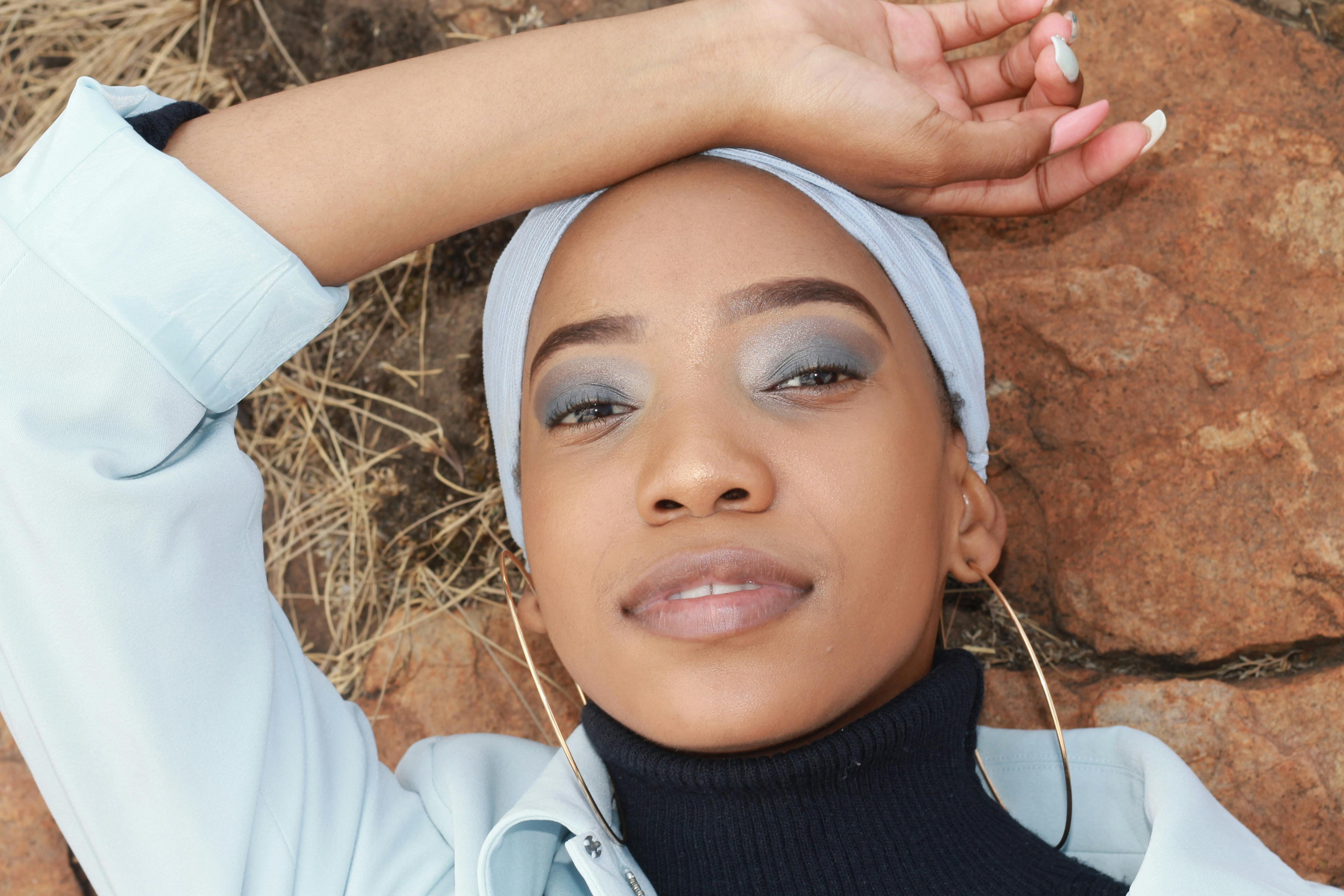 woman in black turtleneck lying on the ground