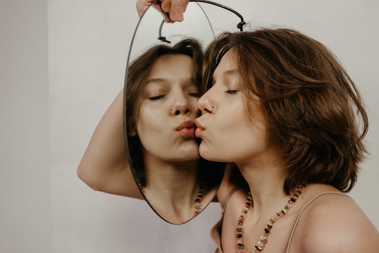 Close-Up Shot Of A Woman Holding A Mirror