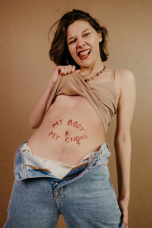 Free Confident young woman embracing empowerment, showing 'My Body My Choice' message. Stock Photo