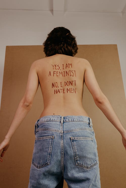 Topless Woman with Message on Back