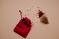 Red Draw String Pouch on Pink Surface