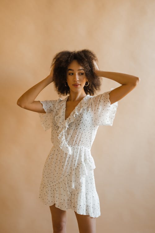 Woman with Curly Hair Wearing White Dress