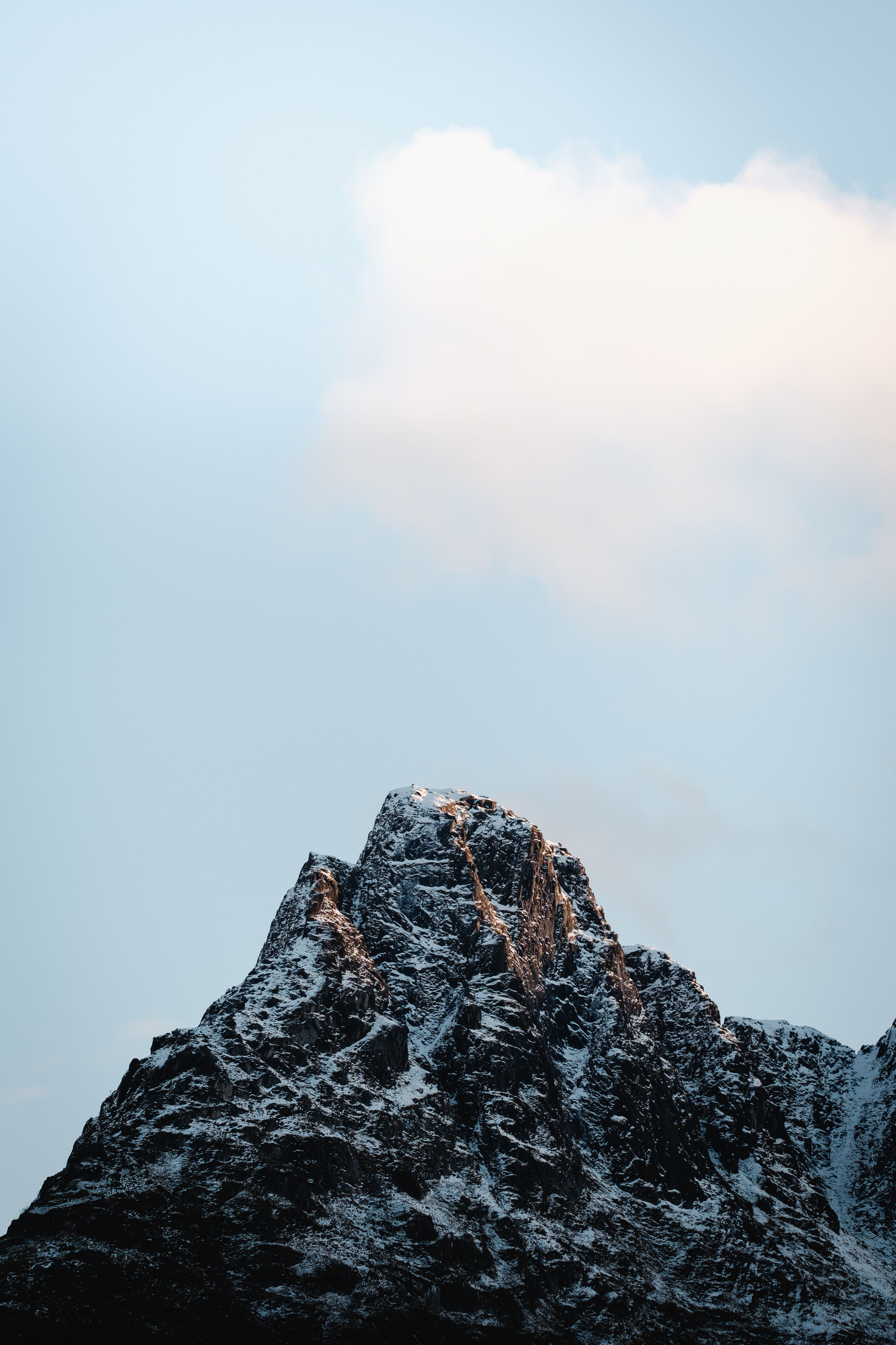 Mountain lake located in snowy valley under blue sky · Free Stock Photo
