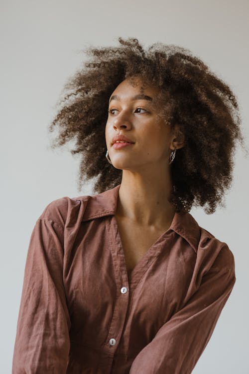 Close Up Photo of Woman with Afro Hair