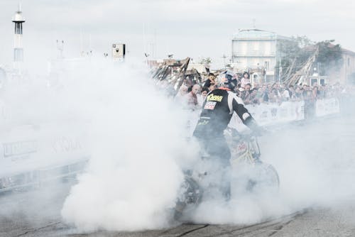 Free Man Riding Motorcycle With Smoke Stock Photo