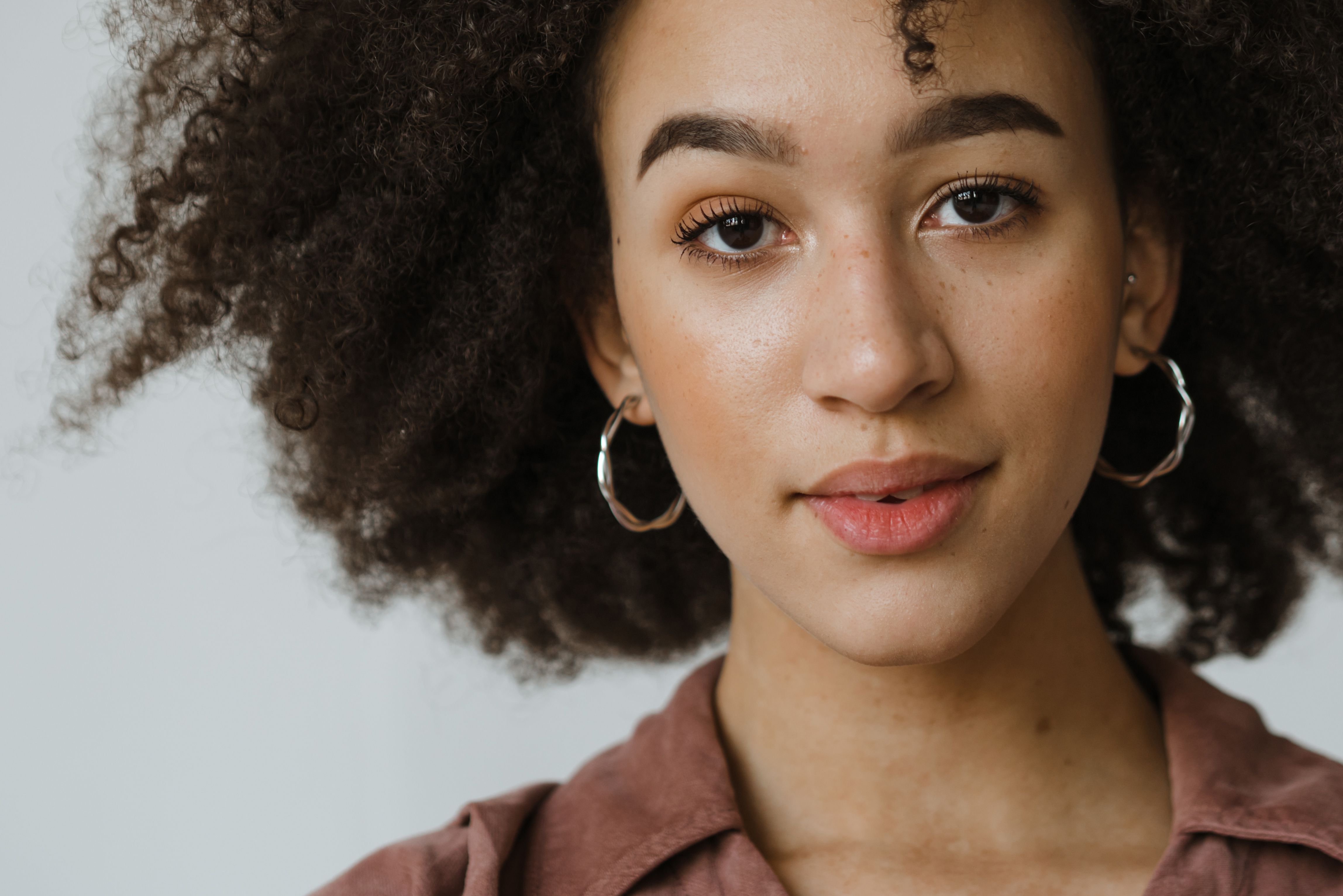 Close Up Photo of Woman Wearing Hoop Earrings · Free Stock Photo