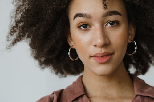 Free Close Up Photo of Woman Wearing Hoop Earrings Stock Photo