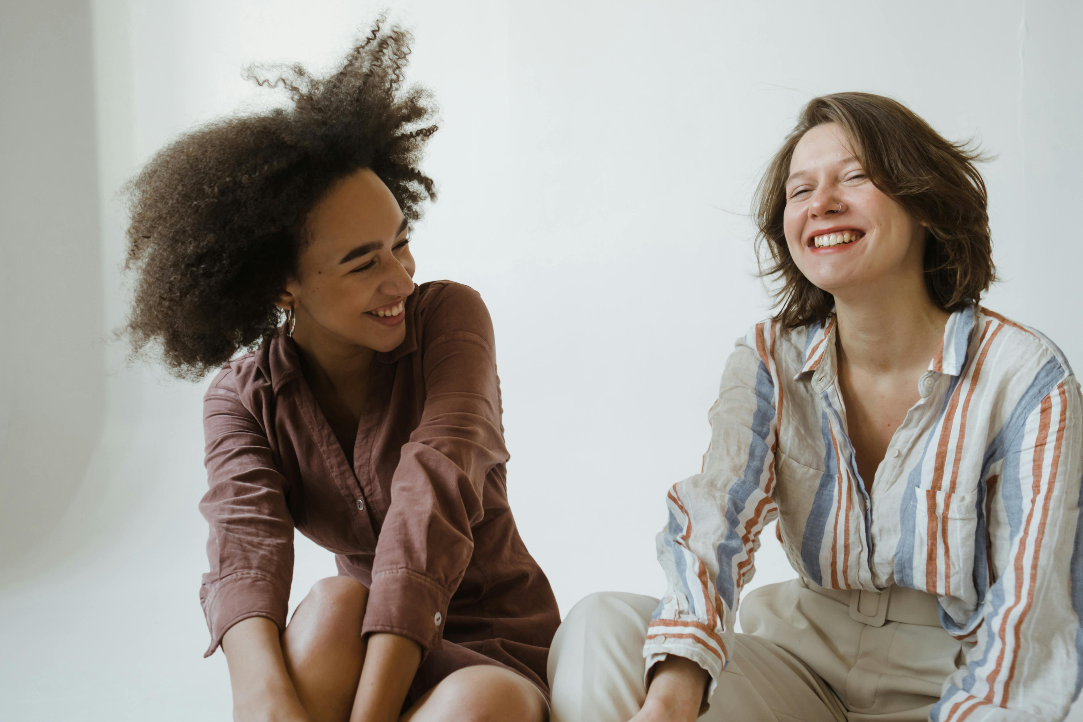 women smiling while sitting on the floor