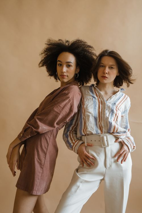 Free Stylish studio portrait of two women exuding confidence and beauty, perfect for fashion and empowerment themes. Stock Photo